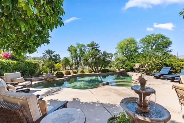 a swimming pool with outdoor seating and yard
