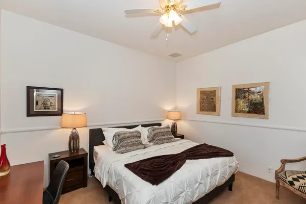 a bathroom with a granite countertop sink a mirror and shower