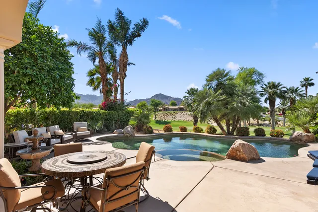 a bedroom with a bed and a mirror