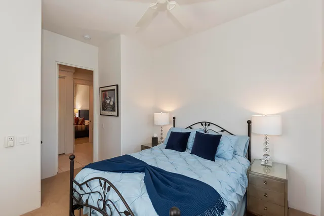 a row of palm trees and swimming pool in the backyard of a house