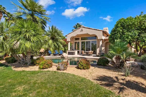 a bedroom with a bed and a mirror