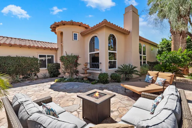 a living room with furniture a fireplace and a large window