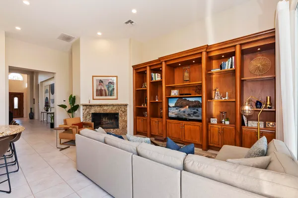 a kitchen with a refrigerator a stove a sink and chairs