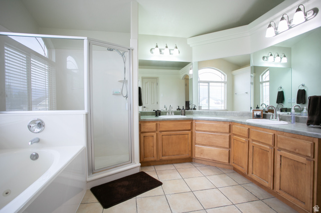 426 Deer Hollow Road Tooele, UT 84074 - Photo 15 of 37 Full bathroom with a garden tub, double vanity, light tile patterned floors, and a shower stall