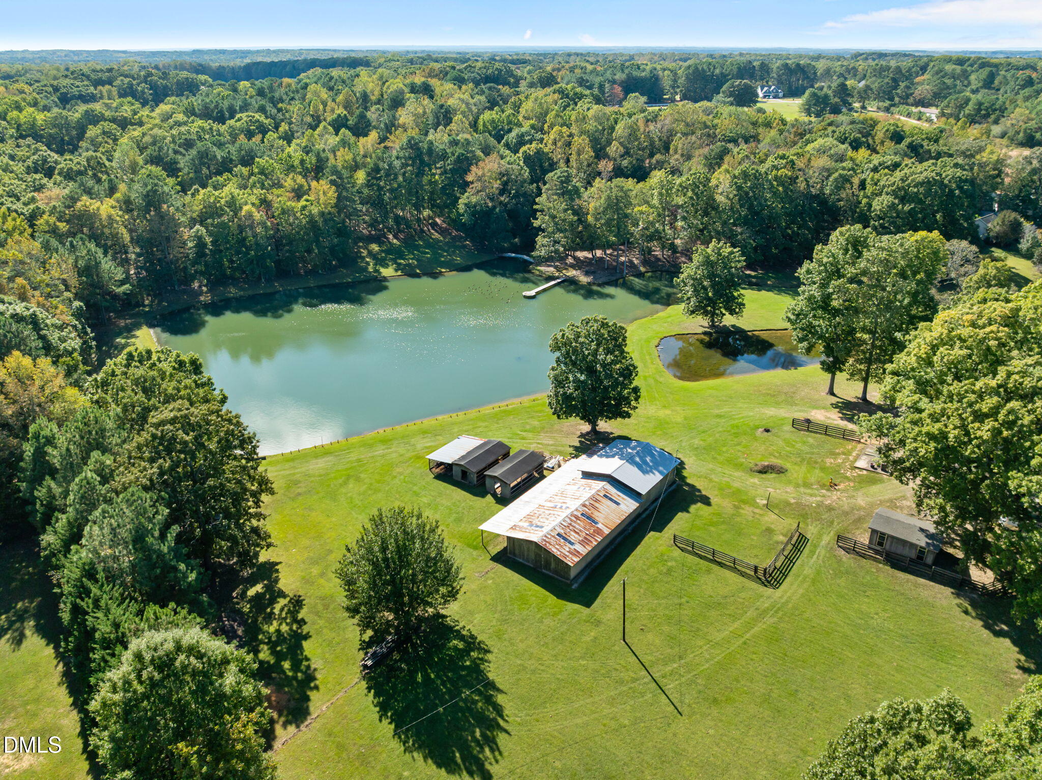 917 John Mitchell Road Youngsville, NC 27596 - Photo 12 of 16 a view of a lake with couches in the back