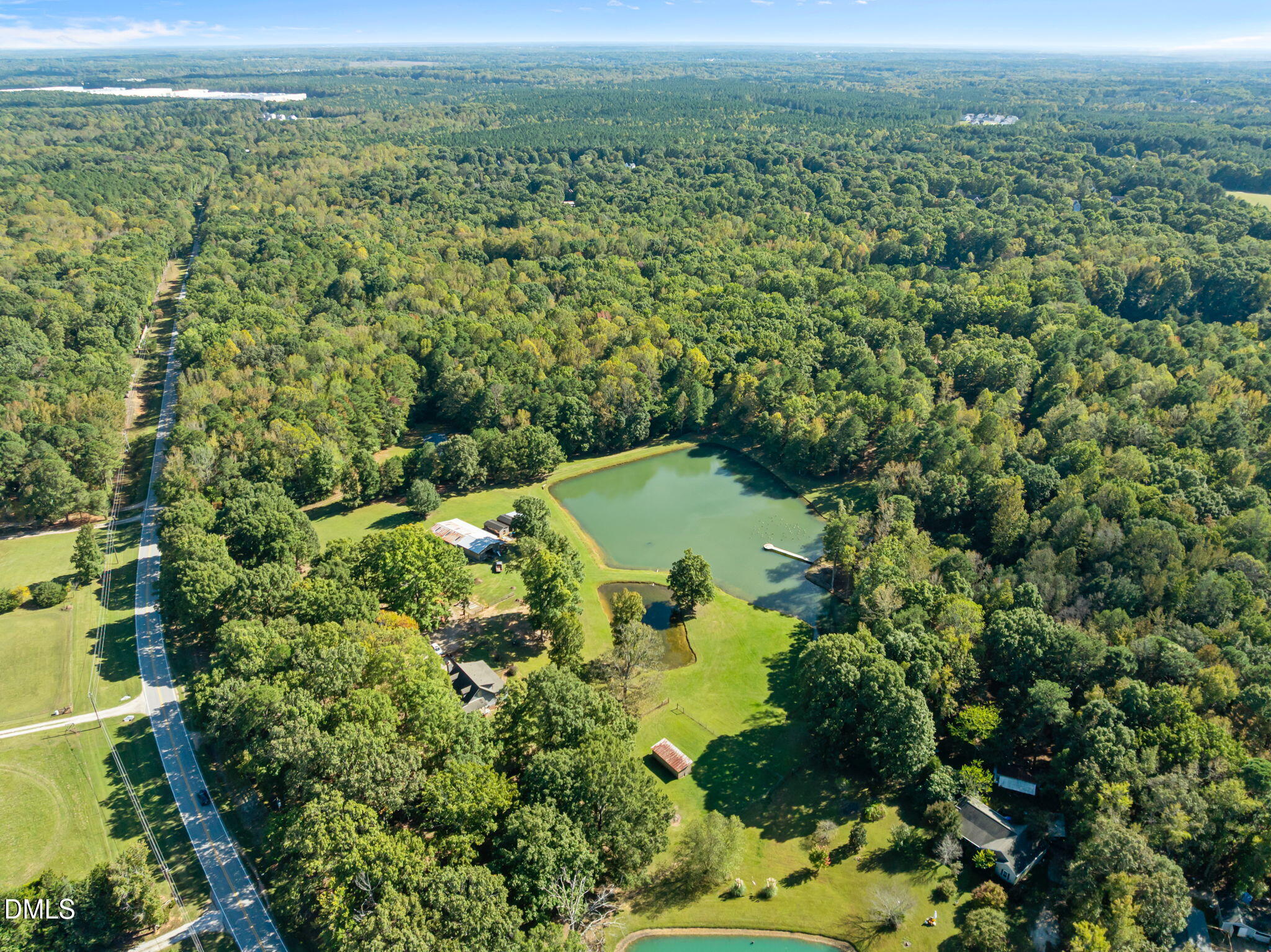 917 John Mitchell Road Youngsville, NC 27596 - Photo 6 of 16 a view of a lake with a forest