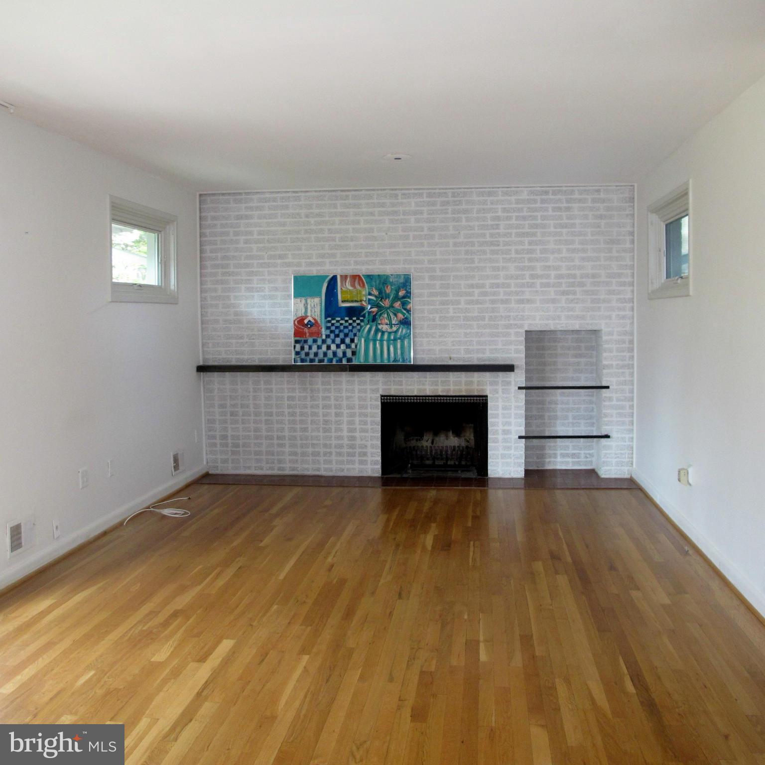 305 Cavalier Court Silver Spring, MD 20901 - Photo 3 of 30 Living Room with Wall of Brick and Fireplace