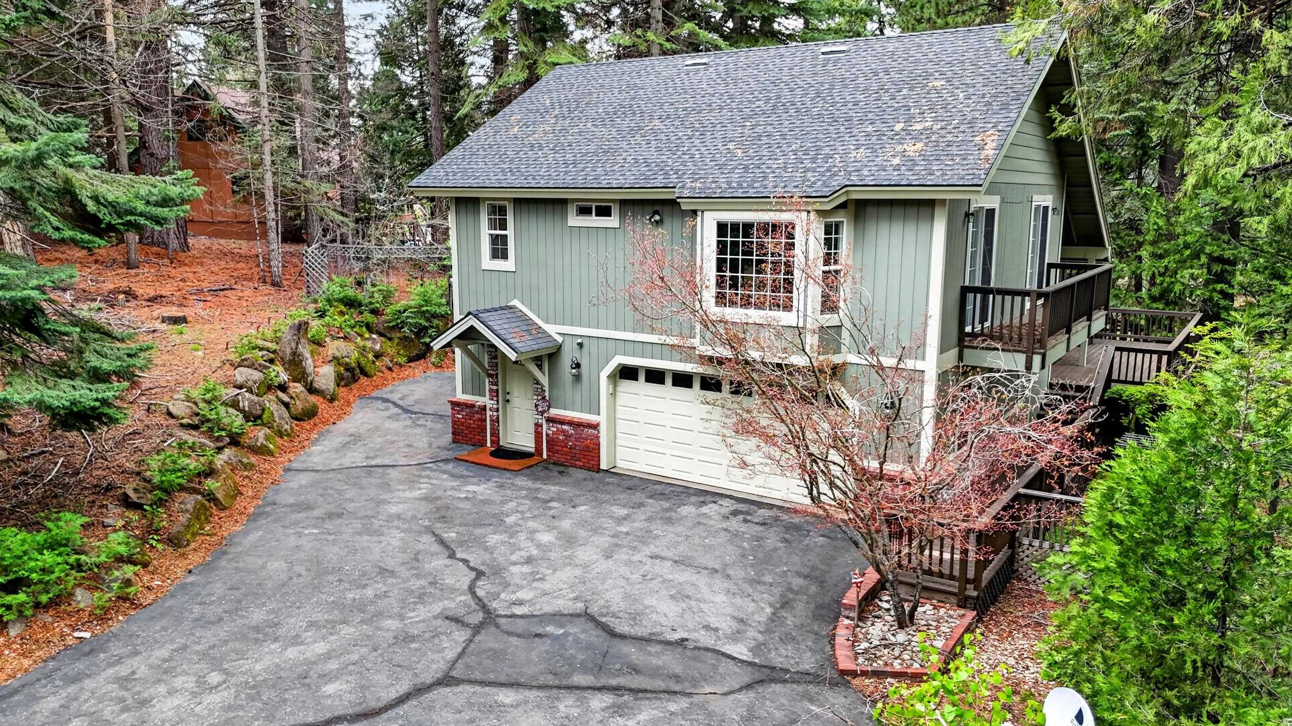 1220 Lynx Road Lake Almanor, CA 96137 - Photo 1 of 45 a backyard of a house with table and chairs