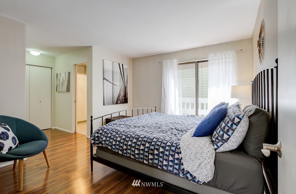 555 Prospect Street, Unit 3 Seattle, WA 98109 - Photo 14 of 23 a bedroom with a bed and wooden floor
