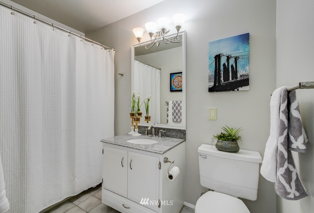 555 Prospect Street, Unit 3 Seattle, WA 98109 - Photo 17 of 23 a bathroom with a toilet a sink and mirror