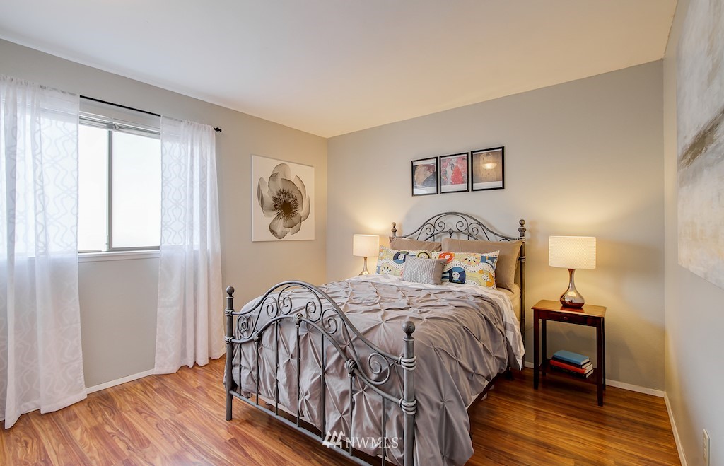 555 Prospect Street, Unit 3 Seattle, WA 98109 - Photo 18 of 23 a bedroom with a bed and wooden floor
