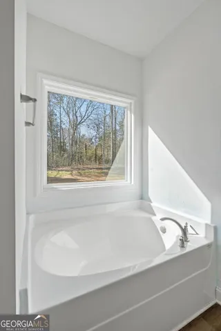 a bathroom with a bathtub and a window