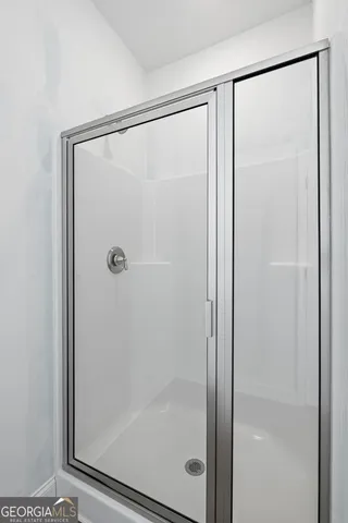 a bathroom with a glass shower door