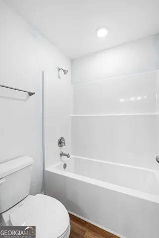 a bathroom with a toilet and a bathtub