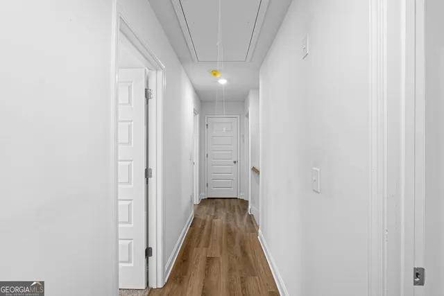 a view of a hallway with wooden floor