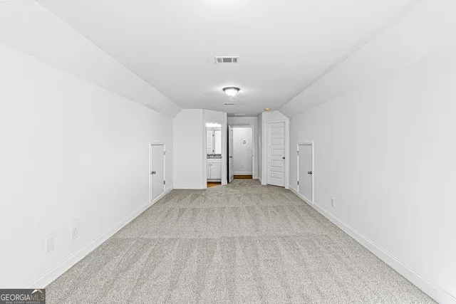 an empty room with a kitchen and a sink