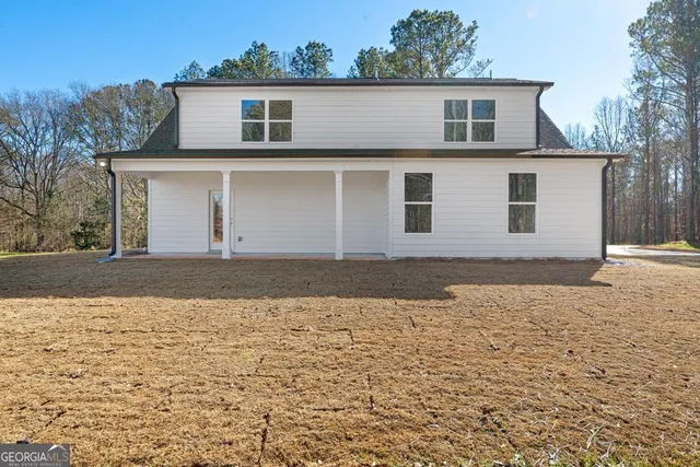 a view of a white house with a yard