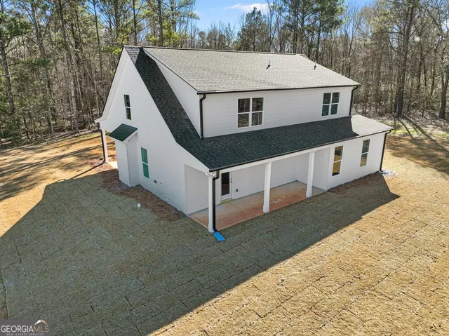 a view of a white house with a yard