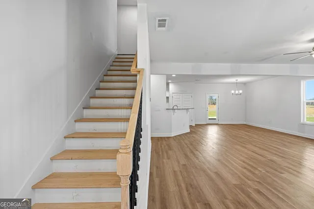a view of entryway and hall with wooden floor