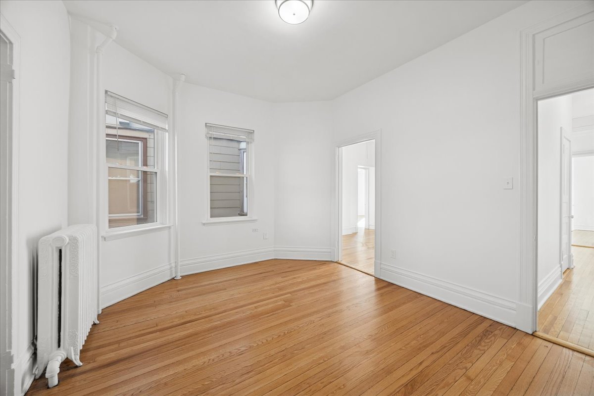 3 East Quincy Street, Unit 2 Riverside, IL 60546 - Photo 14 of 21 a view of an empty room with wooden floor and a window