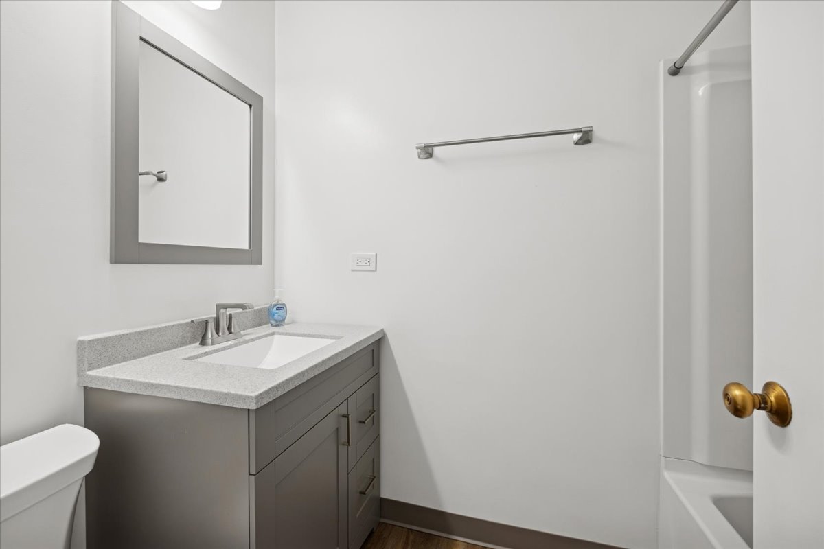 3 East Quincy Street, Unit 2 Riverside, IL 60546 - Photo 15 of 21 a bathroom with a sink and mirror with toilet
