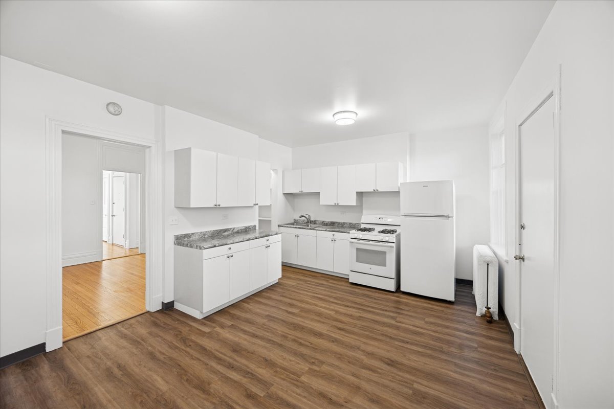 3 East Quincy Street, Unit 2 Riverside, IL 60546 - Photo 19 of 21 a kitchen with stainless steel appliances white cabinets and wooden floor