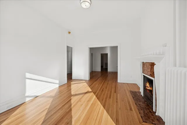 a view of a bedroom with wooden floor and bedroom