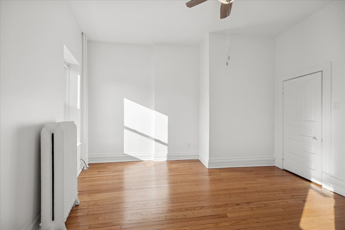 3 East Quincy Street, Unit 2 Riverside, IL 60546 - Photo 8 of 21 a view of empty room with wooden floor and fan