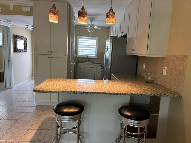 a kitchen with granite countertop a counter space cabinets and stainless steel appliances