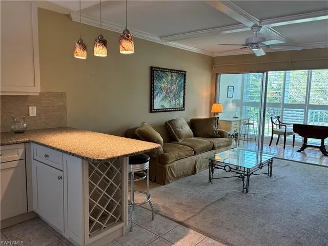 a view of a livingroom with furniture and a ceiling fan