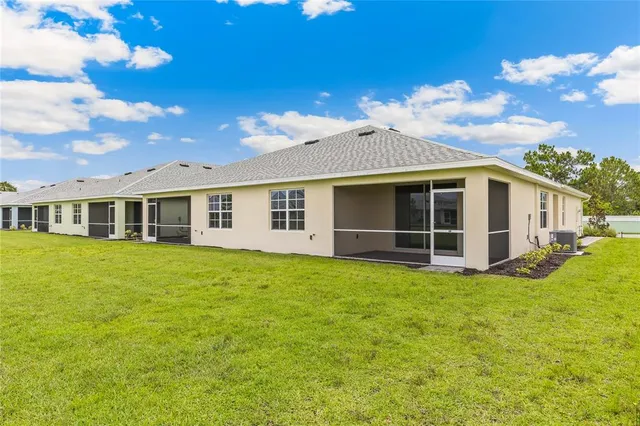 a living room with furniture and large windows