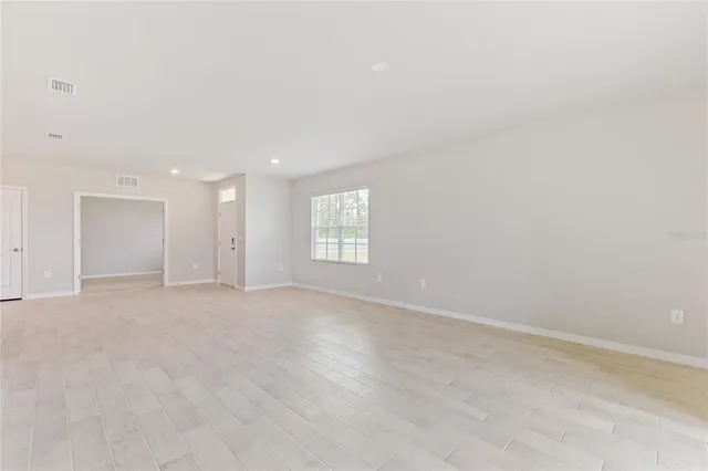 an empty room with an entryway and an empty room