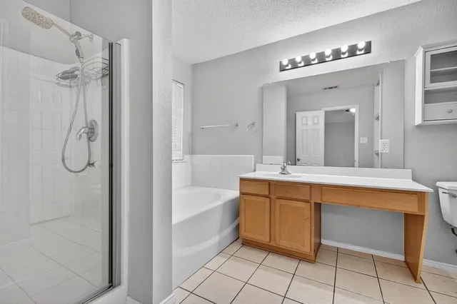 a spacious bathroom with a tub a sink and mirrors