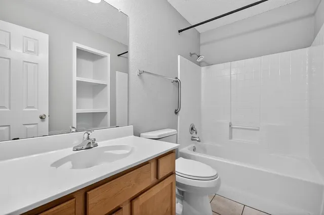a bathroom with a sink toilet vanity and shower