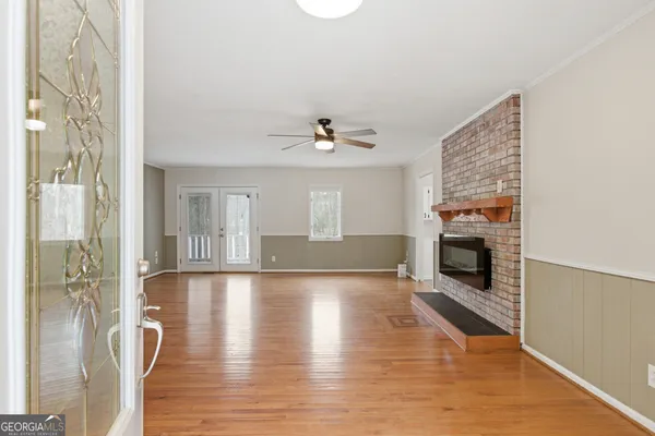 a large kitchen with a stove a sink a counter top space and cabinets