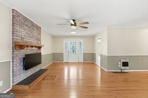 a backyard of a house with lawn chairs and plants