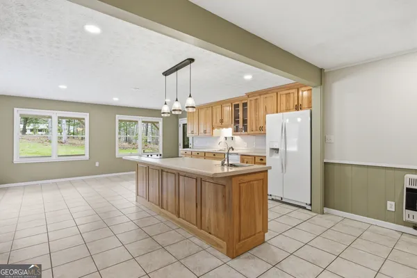 a kitchen with granite countertop white cabinets and stainless steel appliances