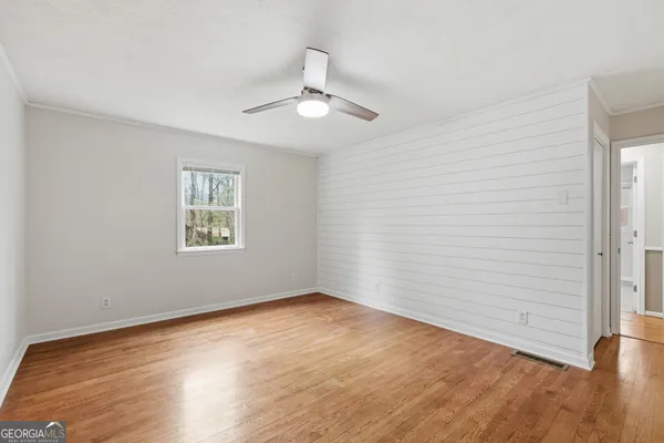 wooden floor in an empty room with a window