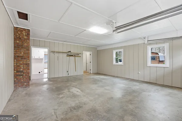 a view of swimming pool with lawn chairs and wooden fence