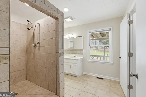 a view of a big house with a big yard and large tree
