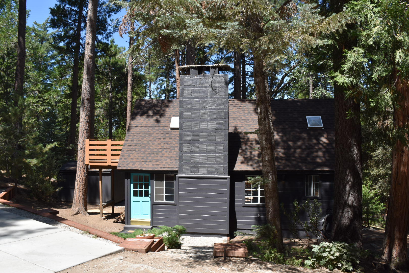 a front view of a house with street and trees