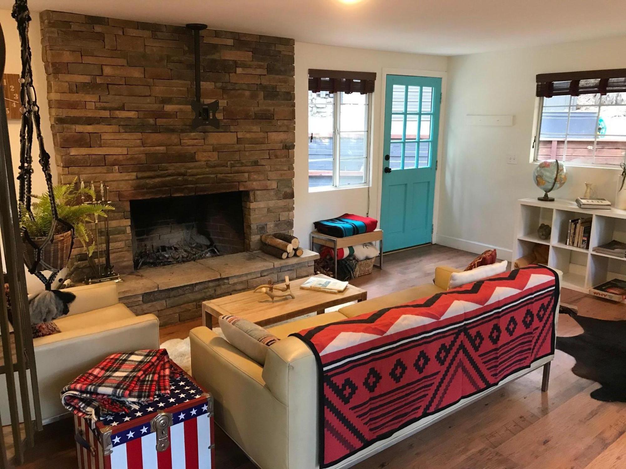 52760 Pine Ridge Road Idyllwild, CA 92549 - Photo 13 of 41 a living room with furniture a flat screen tv and a fireplace