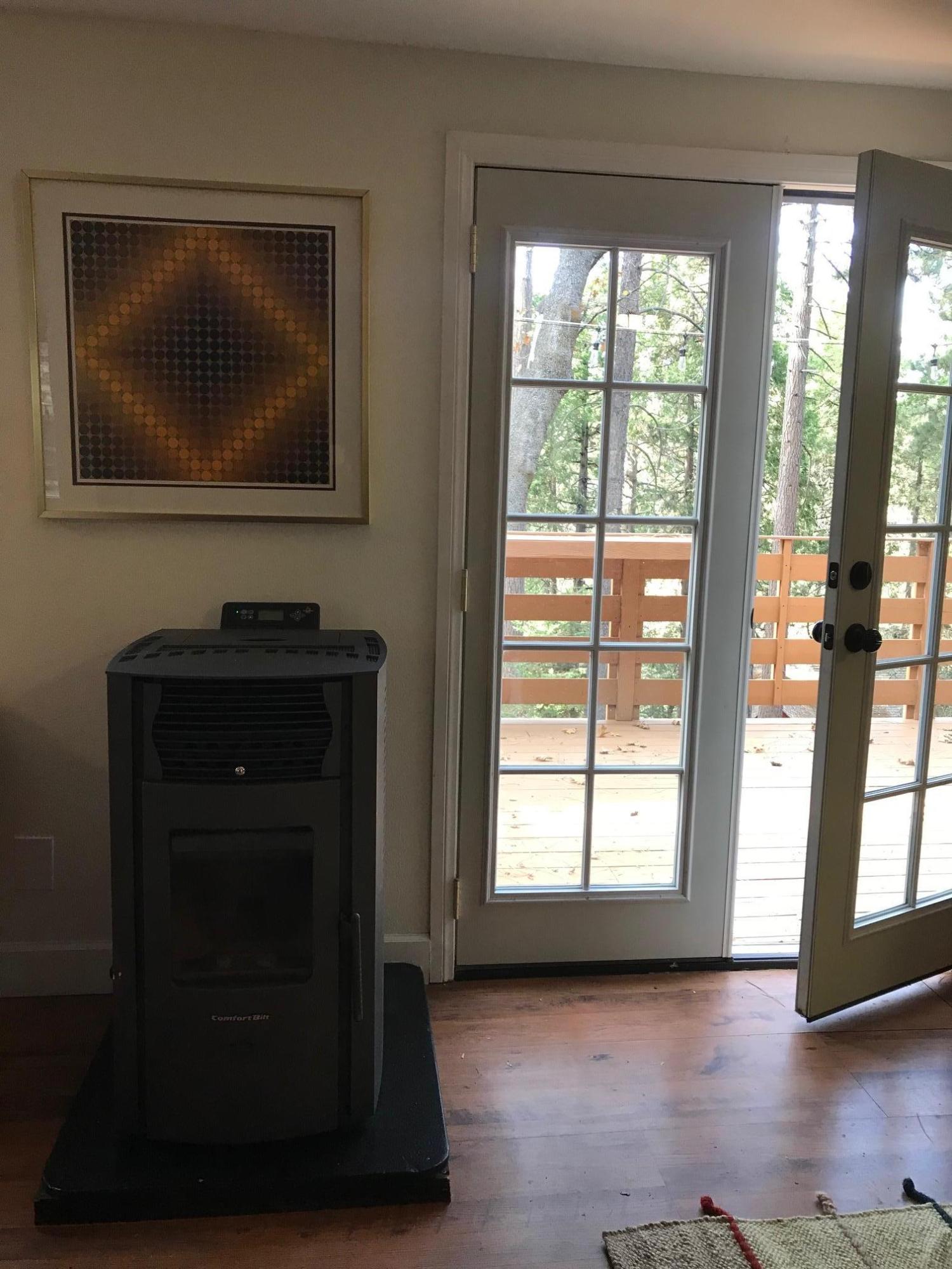 52760 Pine Ridge Road Idyllwild, CA 92549 - Photo 18 of 41 a living room with a fireplace and a flat screen tv