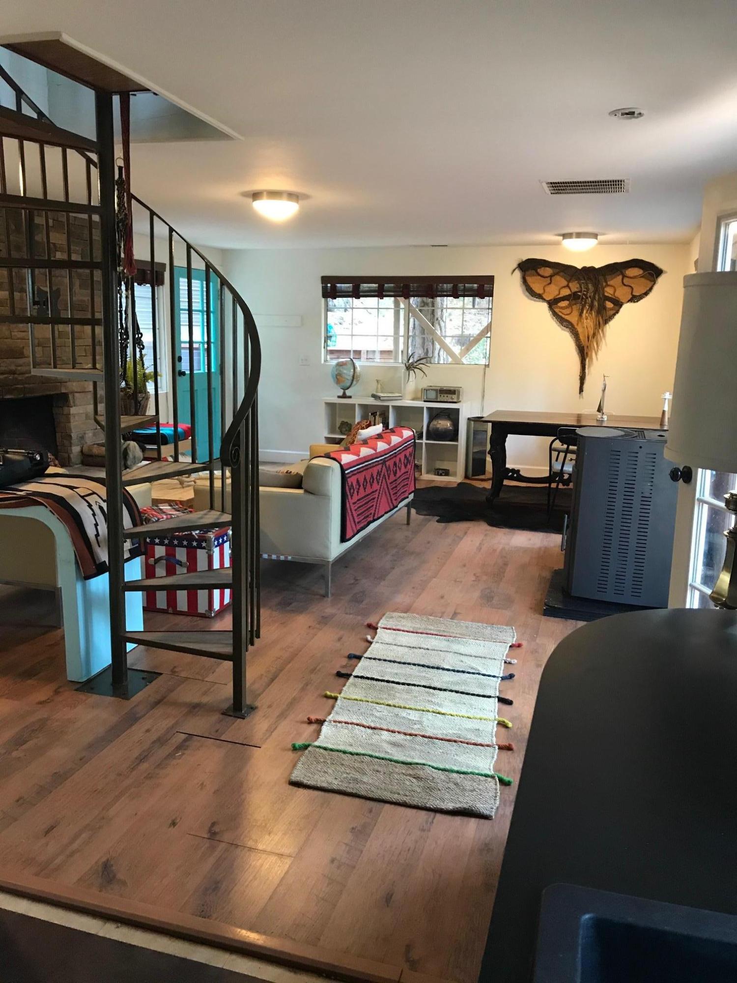 52760 Pine Ridge Road Idyllwild, CA 92549 - Photo 21 of 41 a room with lots of wooden furniture and a window