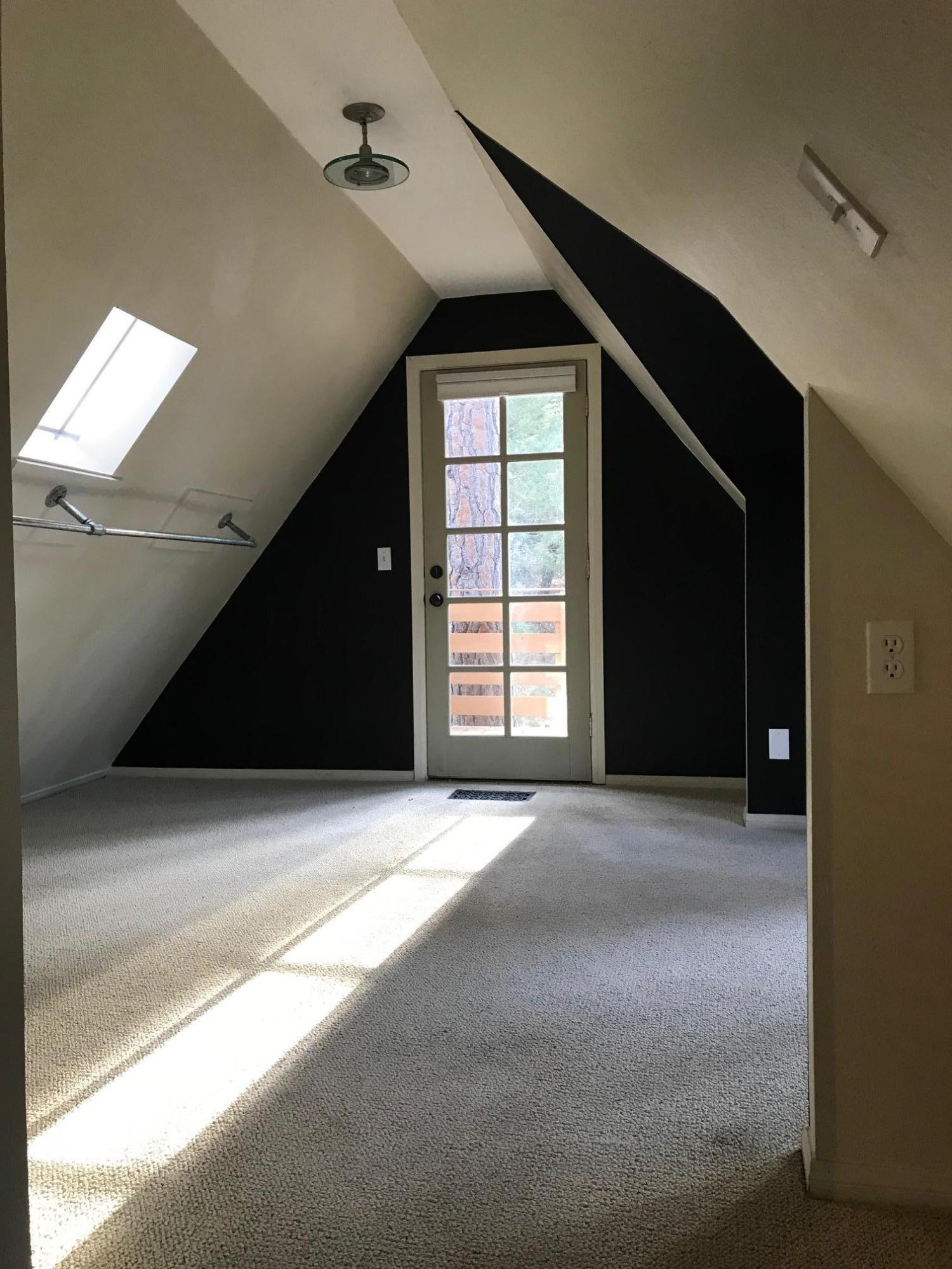52760 Pine Ridge Road Idyllwild, CA 92549 - Photo 29 of 41 a view of an empty room with a window and a kitchen
