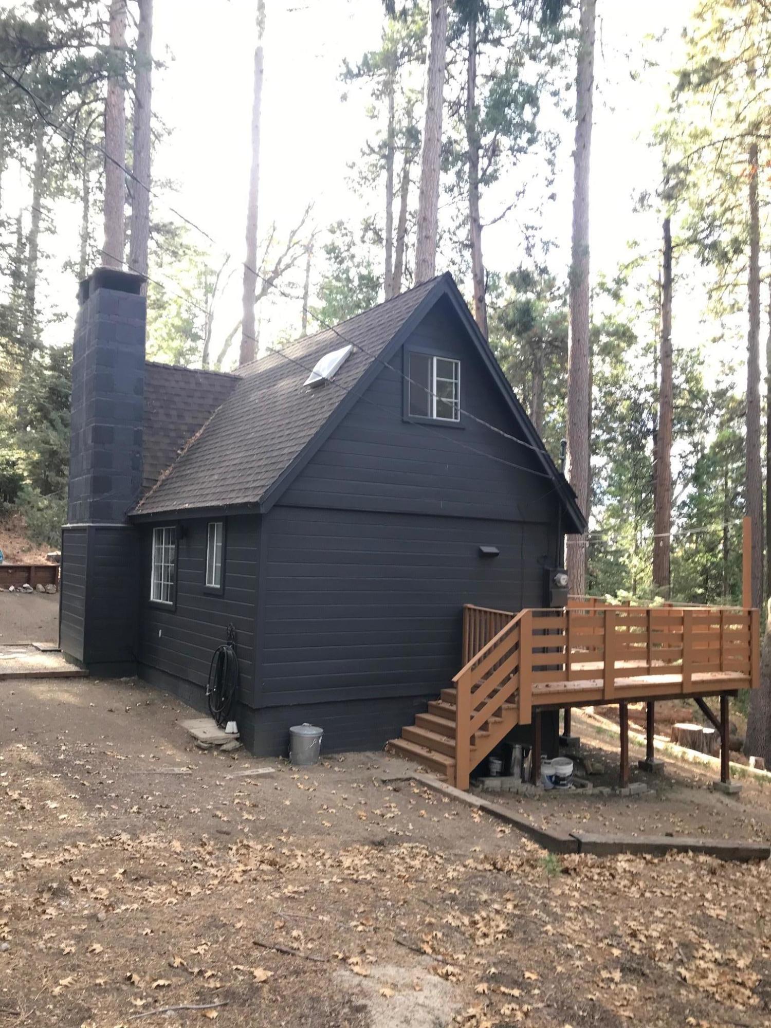 52760 Pine Ridge Road Idyllwild, CA 92549 - Photo 5 of 41 a view of a house with a yard and covered with snow in the background