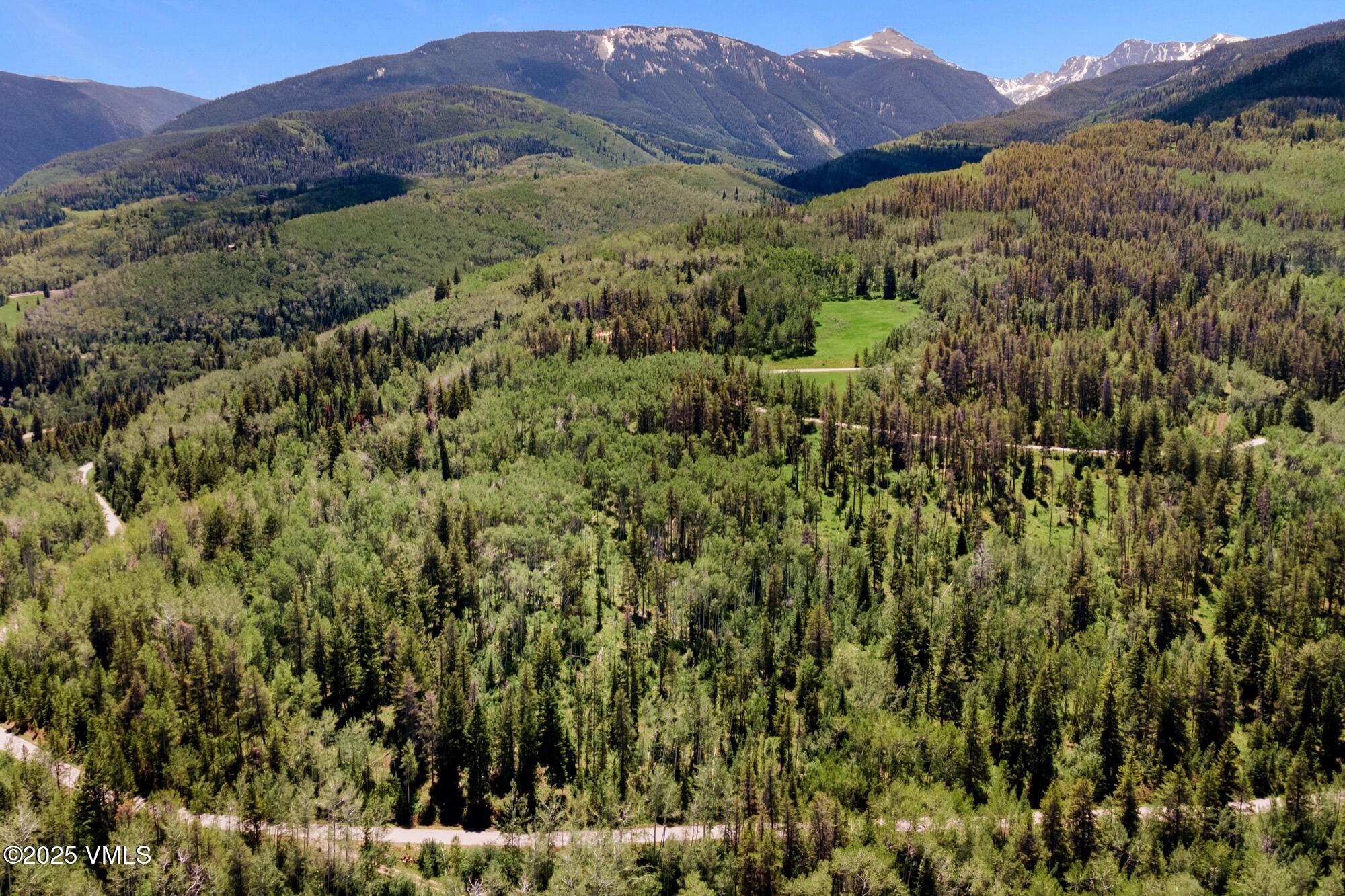 Tbd Casteel Creek Road Edwards, CO 81632 - Photo 2 of 36 a view of a lush green hillside and a building