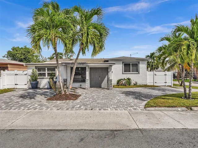 a front view of a house with garden and porch