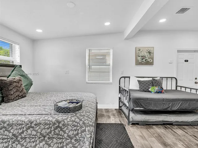 a bedroom with bed and chair