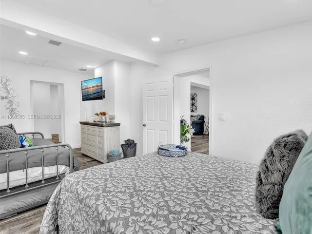 a bedroom with furniture and a wooden floor